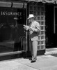 Man holding documents standing in front of insurance company Poster Print - Item # VARSAL25548547