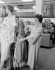 Woman holding dress in clothes shop Poster Print - Item # VARSAL255417874