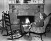 Senior couple sitting in front of a fireplace Poster Print - Item # VARSAL25528222