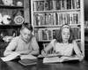 Teenage boy and teenage girl studying at a table Poster Print - Item # VARSAL25516388