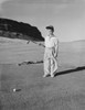 Boy holding golf club at golf course and looking at ball Poster Print - Item # VARSAL255419371