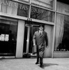 Businessman walking out of bank carrying briefcase Poster Print - Item # VARSAL25548545