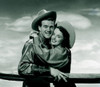 Portrait of cowboy embracing cowgirl Poster Print - Item # VARSAL255417310