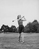 Young woman swinging golf club on golf course Poster Print - Item # VARSAL2554720