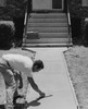 Construction worker smoothing a concrete sidewalk in front of a house Poster Print - Item # VARSAL25537131