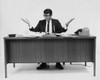 Businessman sitting at a desk in an office Poster Print - Item # VARSAL25548381A