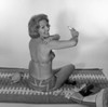 Mid adult woman in bikini applying suntan lotion Poster Print - Item # VARSAL255418003