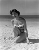 Portrait of pin-up girl wearing bikini  crouching on sandy beach Poster Print - Item # VARSAL255417921