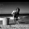 Girl playing on beach Poster Print