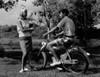 Teenage boy on motorbike  talking to teenage girl Poster Print - Item # VARSAL255424952