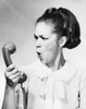 Young woman holding telephone receiver and shouting Poster Print - Item # VARSAL2556449B