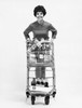 Portrait of a young woman holding a shopping cart Poster Print - Item # VARSAL2557706