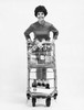 Portrait of a young woman holding a shopping cart Poster Print - Item # VARSAL2557706