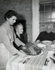 Side profile of a mature woman serving a roasted turkey to her parents on Thanksgiving Day Poster Print - Item # VARSAL25539898