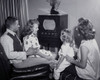 Side profile of parents with their two daughters watching television Poster Print - Item # VARSAL2551613
