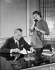 Businessman reading a document and his secretary talking on the telephone beside him Poster Print - Item # VARSAL25548501