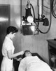 Female radiologist taking an x-ray of a patient Poster Print - Item # VARSAL2556370