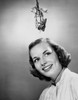 Close-up of a young woman smiling with mistletoe hanging over her head Poster Print - Item # VARSAL25539350