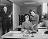 Two businesswomen reading a file and a businessman standing at the door of an office Poster Print - Item # VARSAL25543611B