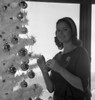 Woman decorating Christmas tree Poster Print - Item # VARSAL255418109