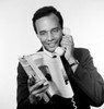Portrait of African american man holding receiver and reading magazine  studio shot Poster Print - Item # VARSAL255417789