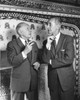 Pair of senior gentlemen smoking cigarettes by fireplace Poster Print - Item # VARSAL25518459