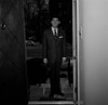 Man wearing suit standing in doorway of house Poster Print - Item # VARSAL255422666