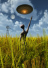 An alien being directing a UFO in making crop circles Poster Print - Item # VARPSTMAS100584S