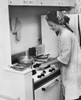Young woman working in a kitchen Poster Print - Item # VARSAL25549239