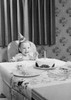 Baby girl wearing birthday hat sitting behind table with birthday cake Poster Print - Item # VARSAL255416330