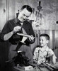 Father repairing a model airplane with his son standing beside him Poster Print - Item # VARSAL25519648 Father repairing a model airplane with his son standing beside him Poster Print - Item # VARSAL25519648