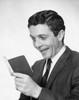 Close-up of a young man holding a bankbook and laughing Poster Print - Item # VARSAL25534312