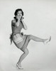 Portrait of a young woman standing on one leg and smiling Poster Print - Item # VARSAL2552389
