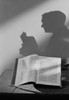 Shadow of man reading open bible Poster Print - Item # VARSAL255421397