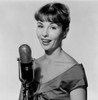 Studio portrait of young woman singing into microphone Poster Print - Item # VARSAL255417883