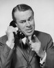 Mid adult businessman talking on telephone Poster Print - Item # VARSAL25548237