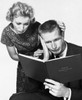 Close-up of a mid adult couple reading a family budget book Poster Print - Item # VARSAL25520827A