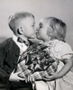 Close-up of a boy and a girl holding a Valentine gift and kissing each other Poster Print - Item # VARSAL2553617