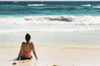 Young woman sitting on sandy beach in water looking out at waves coming in and blue sky; Akumal, Quintana Roo, Mexico PosterPrint - Item # VARDPI12269299