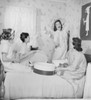 Four young women fitting hats in bedroom Poster Print - Item # VARSAL255422708B