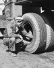 Auto mechanic repairing a truck tire Poster Print - Item # VARSAL25527516