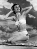 Portrait of young woman sitting on beach Poster Print - Item # VARSAL255417479