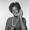 Young African-American woman holding receiver  studio shot Poster Print - Item # VARSAL255417807