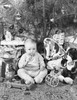 Boy sitting near Christmas presents and eating a candy cane Poster Print - Item # VARSAL25539399