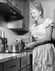 Mid adult woman preparing food in a domestic kitchen Poster Print - Item # VARSAL25535461