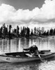 Mid adult man sitting on a rowboat and fishing in a lake Poster Print - Item # VARSAL2556171