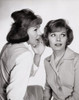 Close-up of two young women whispering Poster Print - Item # VARSAL25525172