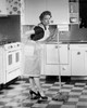 Young woman standing in kitchen holding mop Poster Print - Item # VARSAL25527953