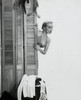 Young woman peeking from behind a screen partition Poster Print - Item # VARSAL2551193