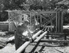 Manual worker sawing a wooden plank on a construction site Poster Print - Item # VARSAL25525307